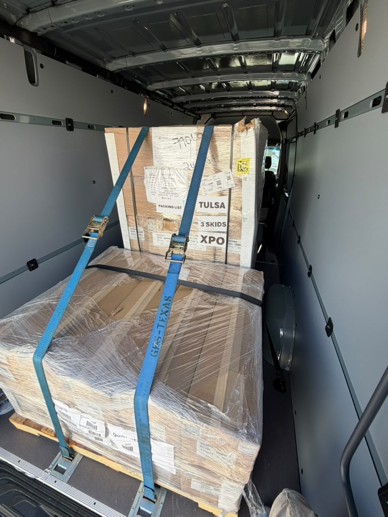 Multiple skids strapped in the van