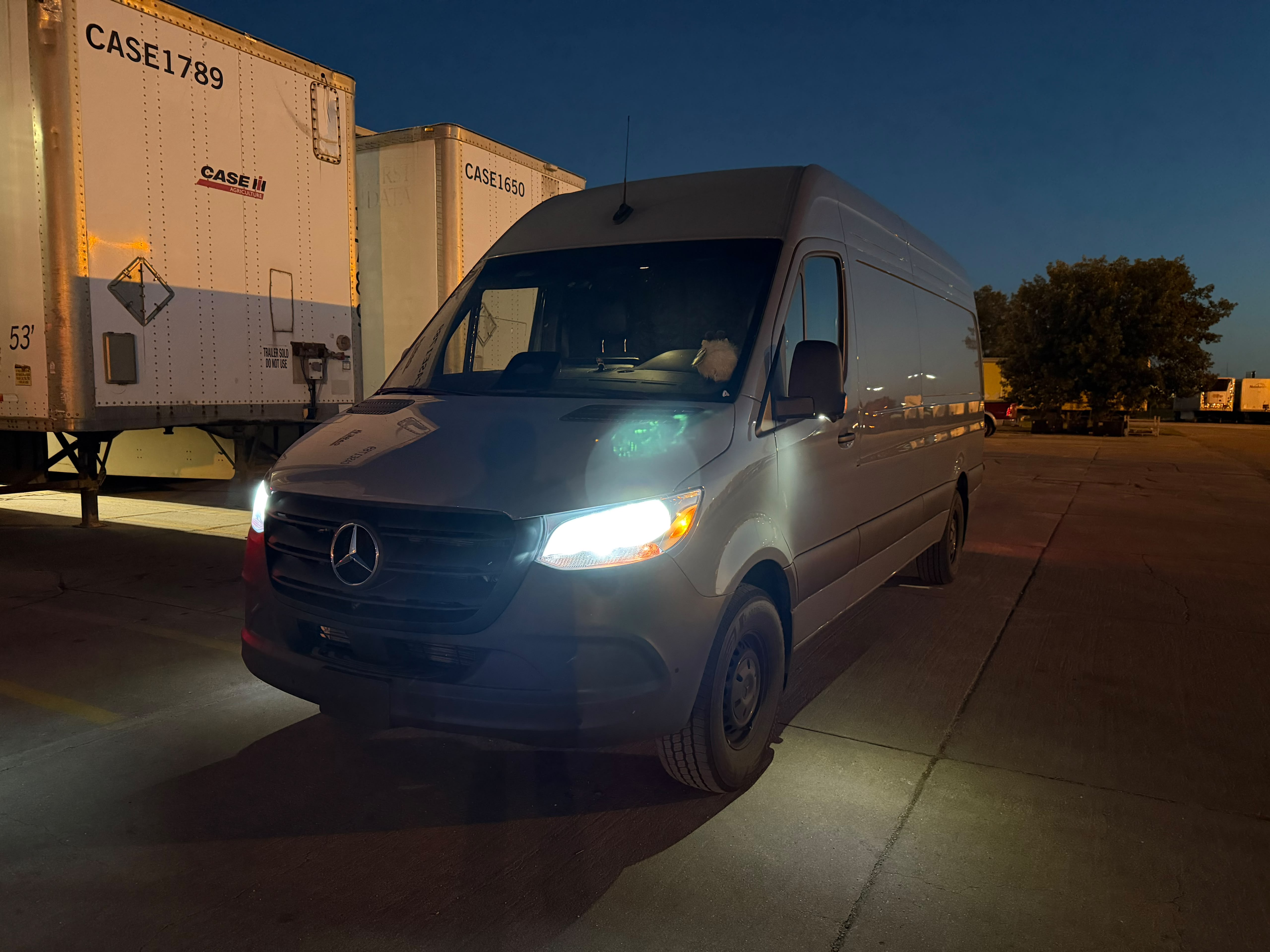 Sprinter running at dusk beside 53-foot trailers