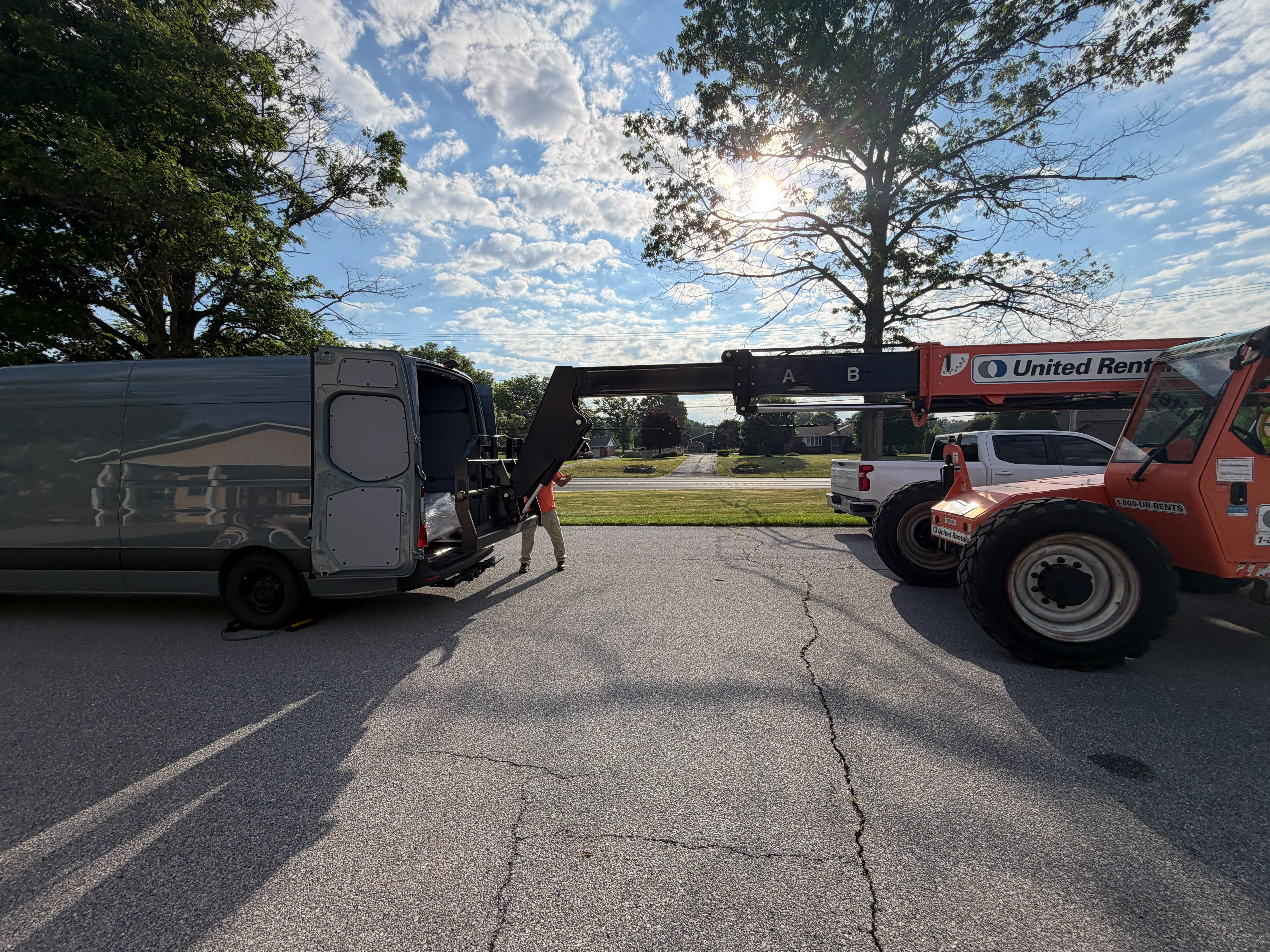 Telehandler loading an oversized load into the van